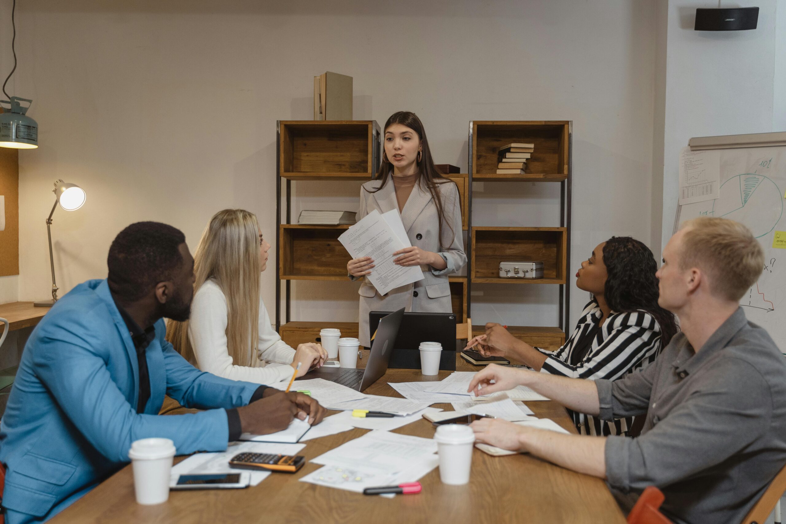 Woman in a gray blazer presenting her leadership development plan