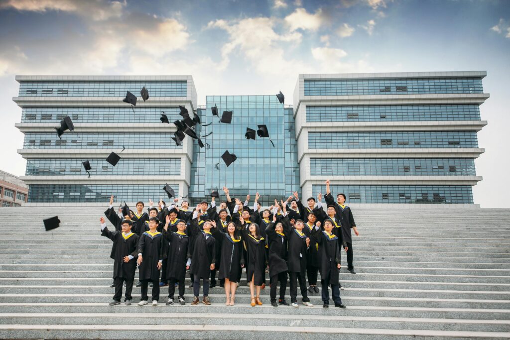 A group of graduates tossing their graduation caps.